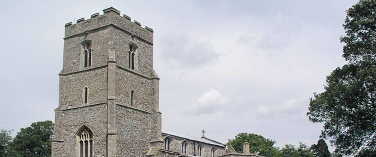 A historic stone church with a prominent tower and multiple arched windows.