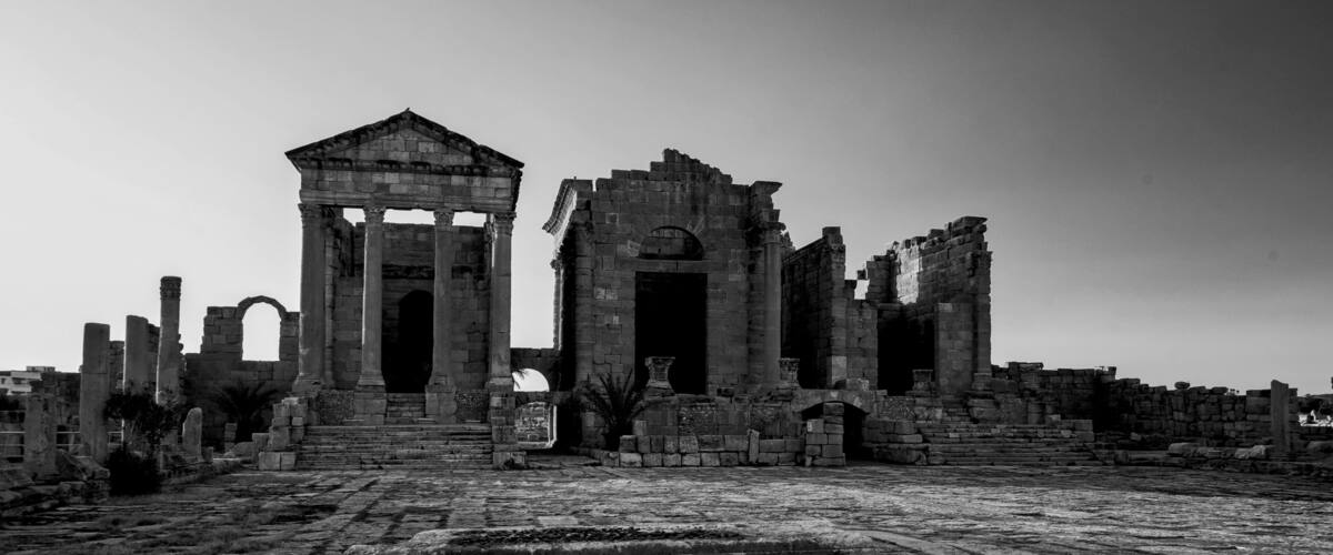 Ancient ruins with columns and arches.