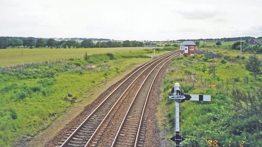 Site of former Inverkeilor station. View SW, towards Arbroath, Dundee etc.: ex-NBR Edinburgh/Glasgow - Dundee - Arbroath - Montrose - Aberdeen main line. Nothing is left of the station, which closed 22/9/30, but there is what appears to be a signalbox - ?? converted into a house.