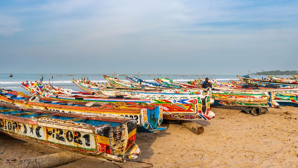 Colorful boats on a sandy beach by the sea.