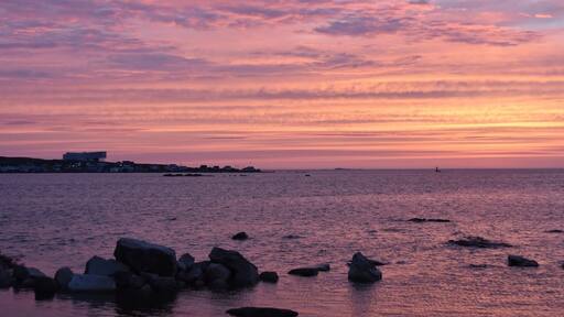 The Fogo Island Inn in the distance at sunset.