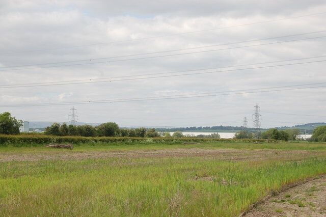 Powerlines crossing the Caldicot Levels near Redwick View looks northwards across the Caldicot Levels. Llanwern steelworks can be seen in the background on the left. The powerlines lead from/to Uskmouth Power Station.