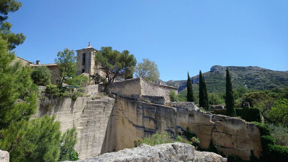 A stone tower on a hill with a clear blue sky.