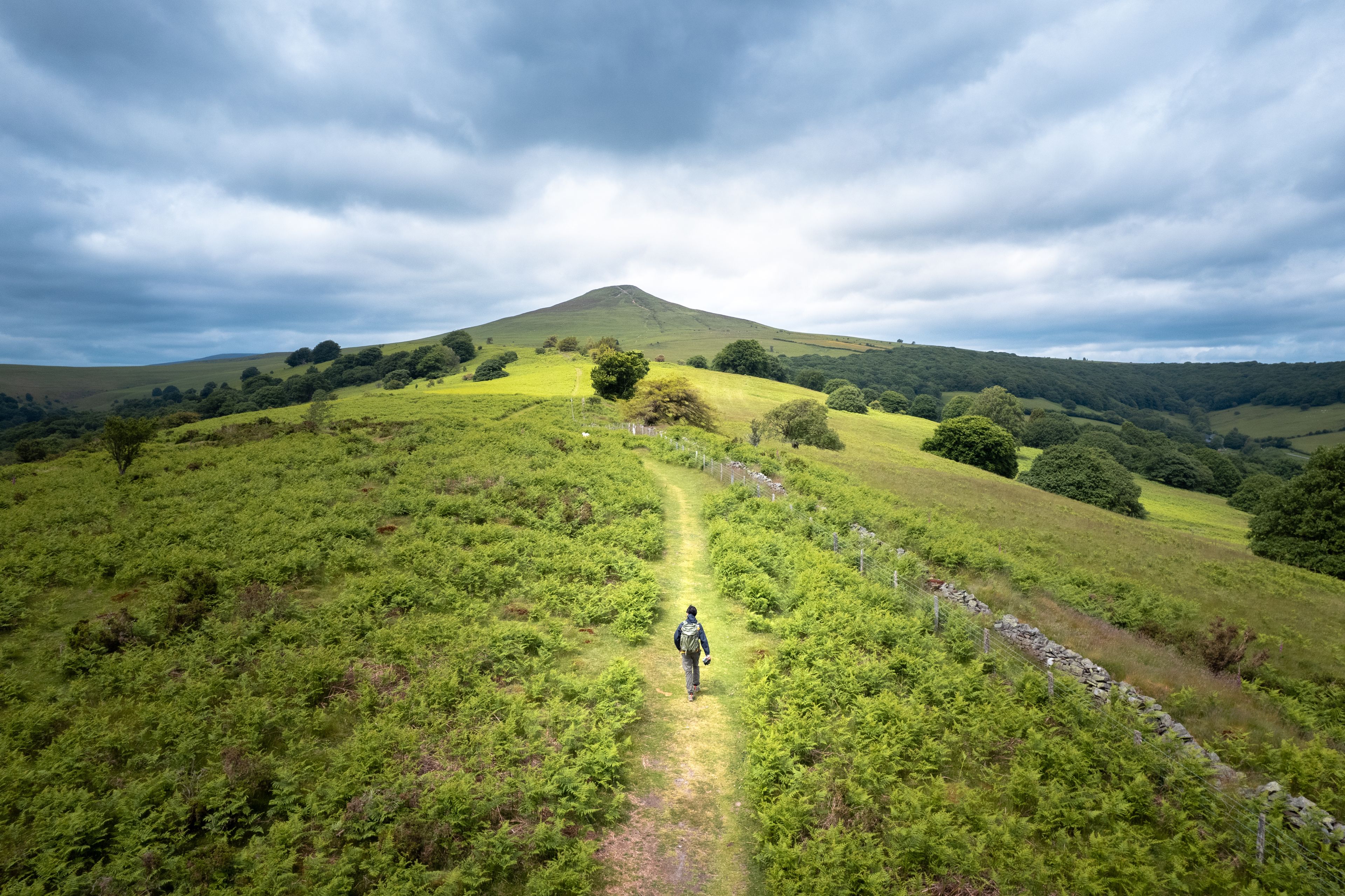 backpack hiker on the Sugar Loaf, mountain peak, Abergavenny, Monmouthshire Wales, United Kingdom