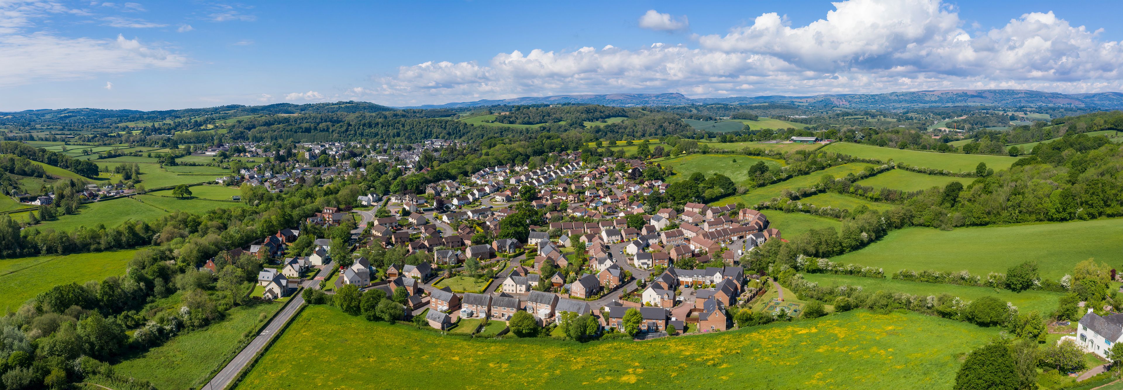 Panoramic view of the residential housing estate in Usk, south Wales, with the town of Usk in the distance.