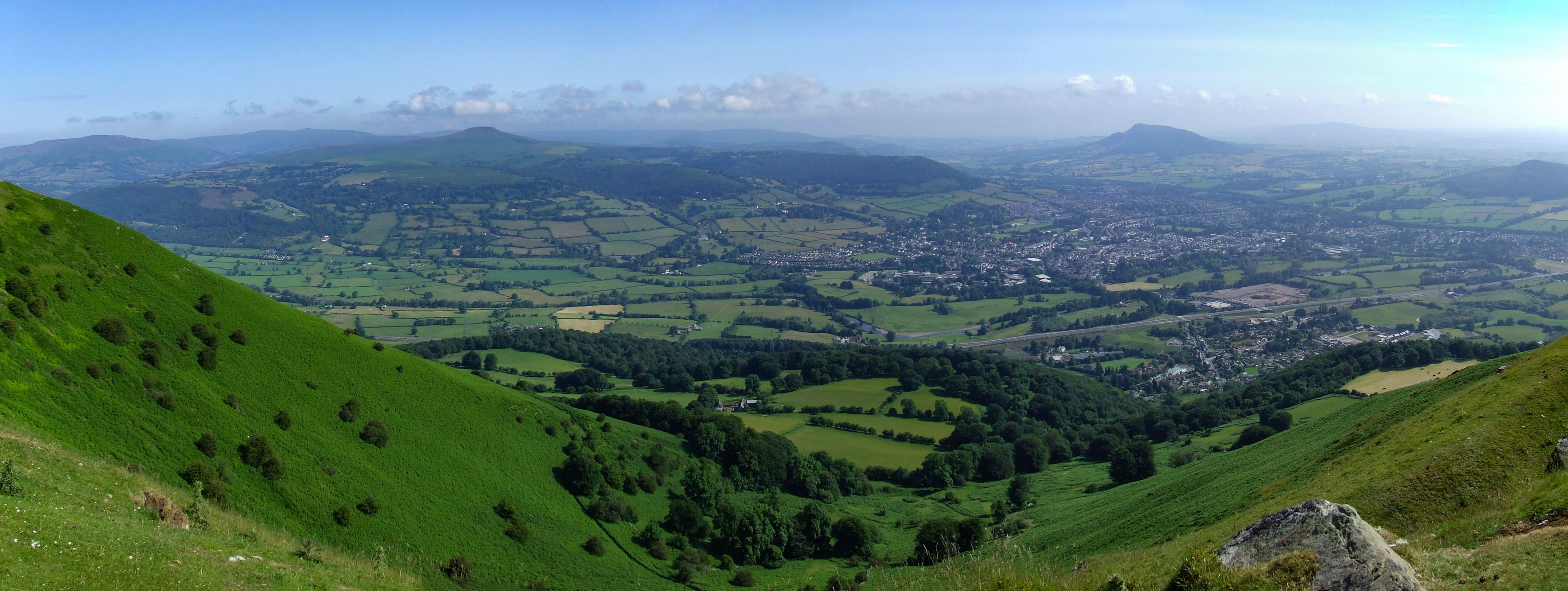 View from Blorenge (Blorens) looking across Abergavenny (Y Fenni) towards Sugar Loaf (Mynydd pen y fal) and Skirrid Fawr (Ysgyryd Fawr) at Brecon Beacons National Park, Monmouthshire, Wales