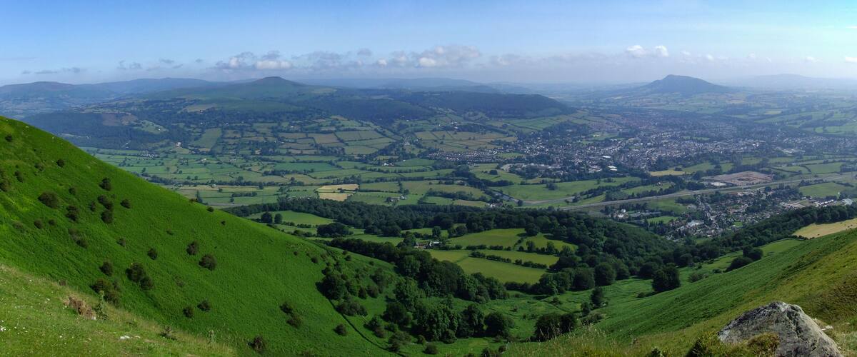View from Blorenge (Blorens) looking across Abergavenny (Y Fenni) towards Sugar Loaf (Mynydd pen y fal) and Skirrid Fawr (Ysgyryd Fawr) at Brecon Beacons National Park, Monmouthshire, Wales