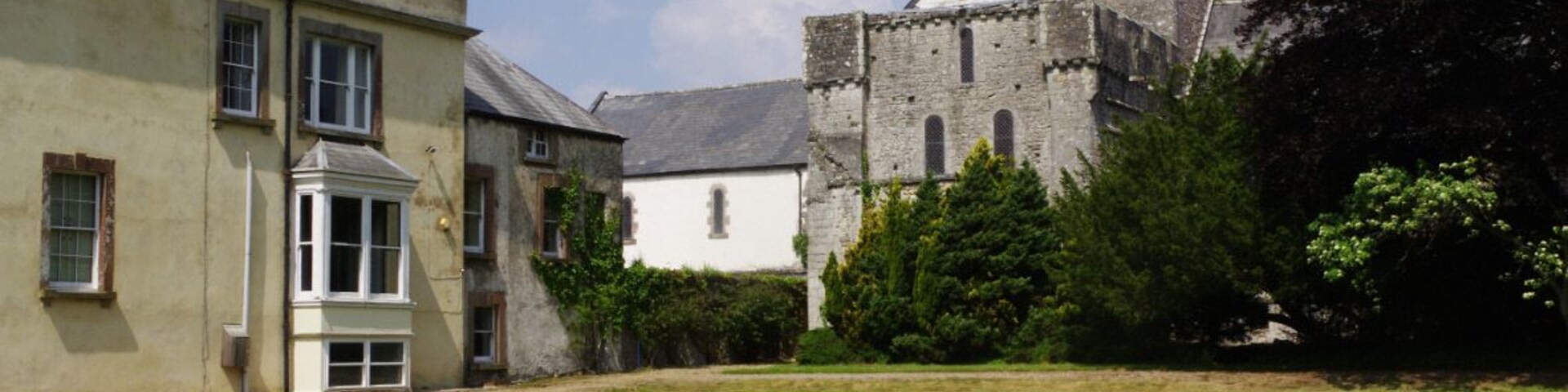 The church of St Michael and All Angels is a fine example of a Norman church, still very much in use today. To the left is Ewenny Priory House.