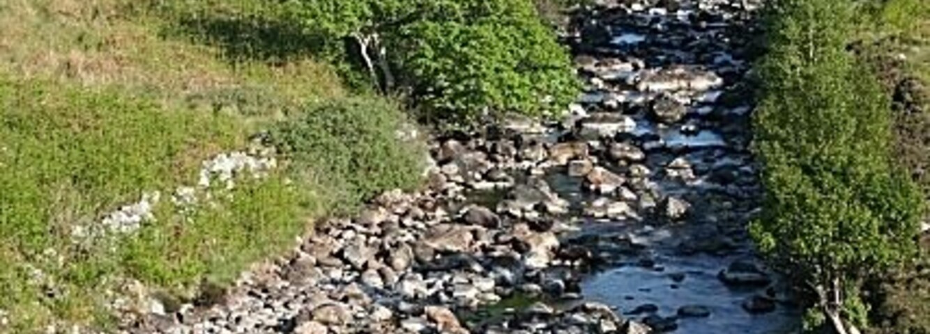 The Old Bridge from the New Bridge The more elevated viewpoint on the new bridge provides a much more satisfying view than was previously possible. The mountain in the distance is Arcuil (Arkle).