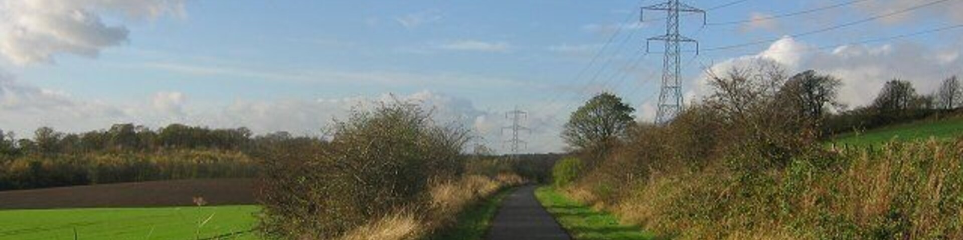 Dunfermline-Alloa railway. Now a cyclepath. Entering the square beneath Carneil Hill. Looking west.