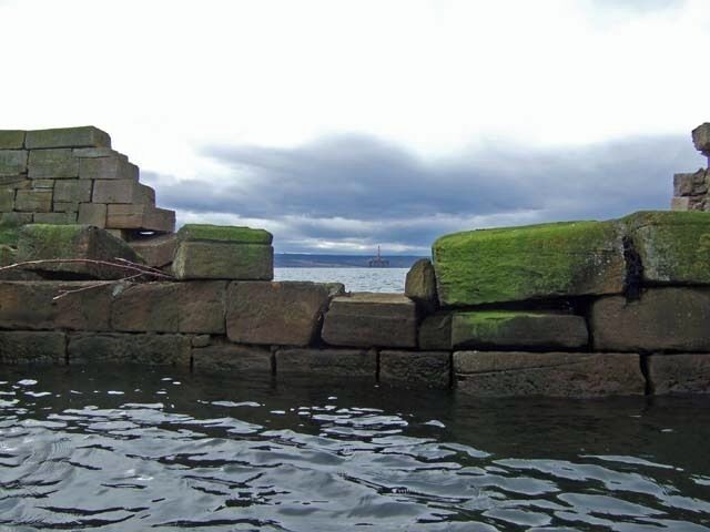 Ruined Balintraid Pier The ruined old pier of Balintraid frames the new oil drilling platform in the distance.