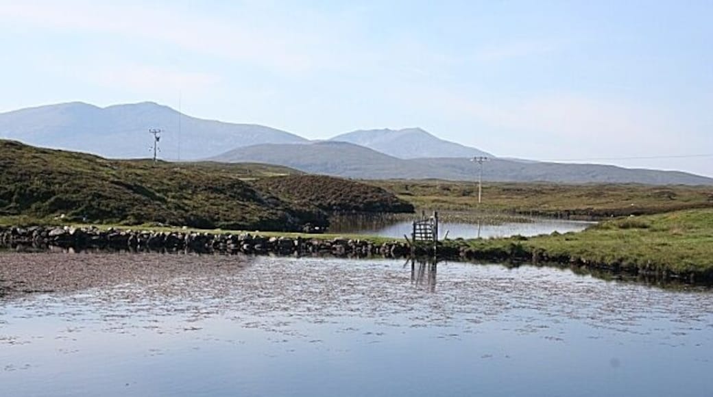 Loch a' Chnoic Bhric This looks like a causeway or wall across the narrowest part of the loch. Beyond are Thacla (Hecla) and Beinn Mhòr.