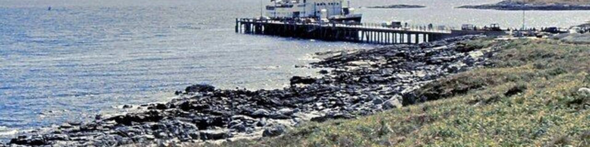 Arinagour Pier, Coll, Argyll, with the former Caledonian MacBrayne ferry MV Columba (now the cruise ship MV Hebridean Princess).