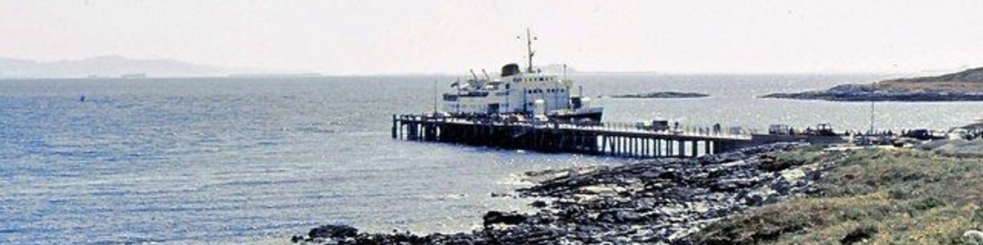 Arinagour Pier, Coll, Argyll, with the former Caledonian MacBrayne ferry MV Columba (now the cruise ship MV Hebridean Princess).