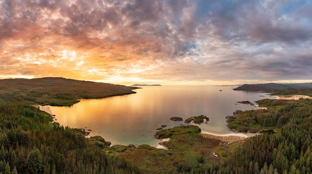 Aerial view of Singing sands and Cul na Croise beach with Eigg and Rum at sunset, Scotland