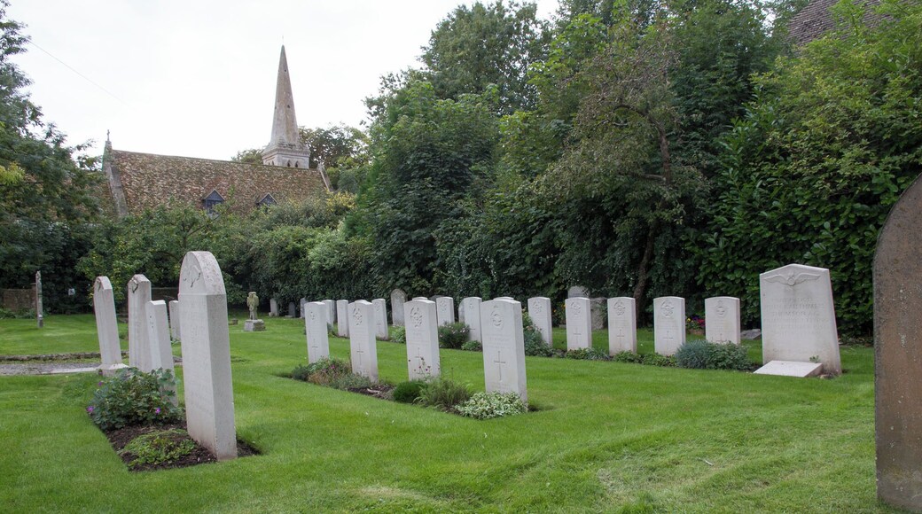 Commonwealth War Graves section of All Saints' parish churchyard, Wyton, Cambridgeshire (formerly Huntingdonshire), with the church beyond the hedge. The graves are of airmen from RAF Wyton.