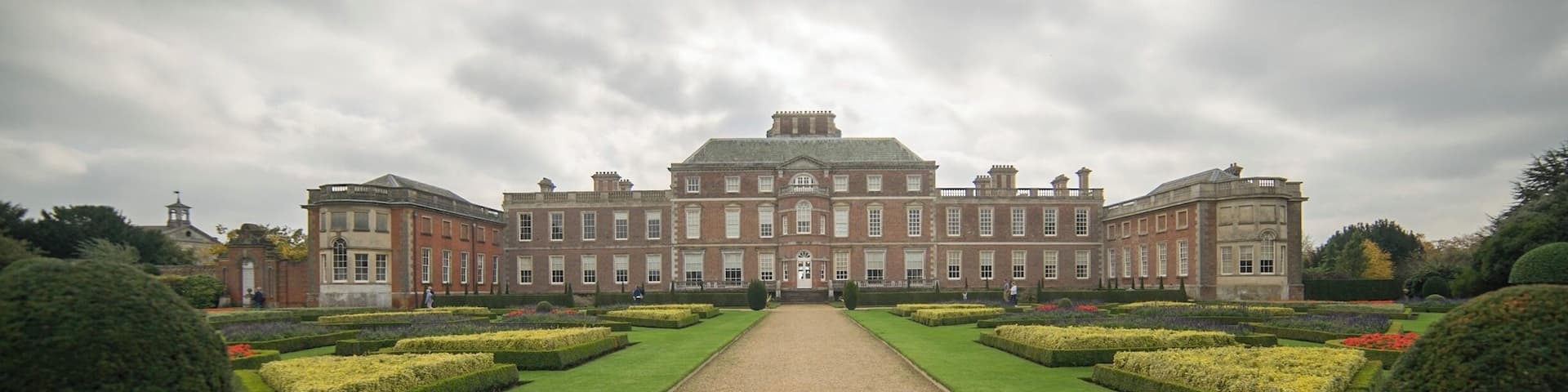 A large, symmetrical building with a central pathway leading to a grand entrance.