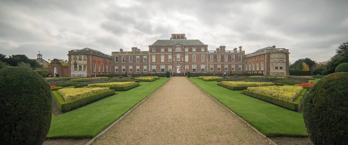 A large, symmetrical building with a central pathway leading to a grand entrance.