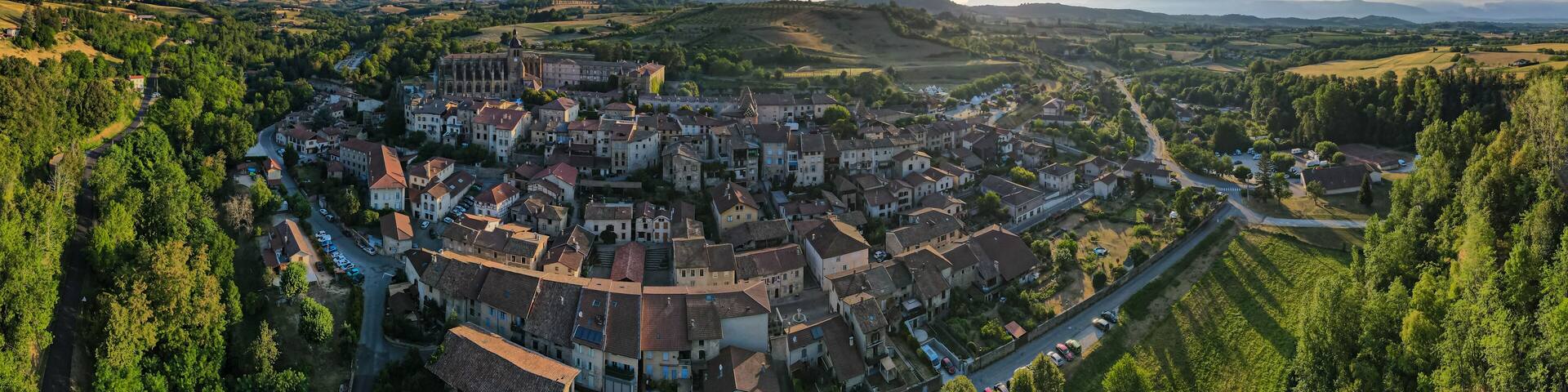 Early morining aerial sunrise shot of Saint-Antoine-l'Abbaye the Morning of the summer médiéval festival