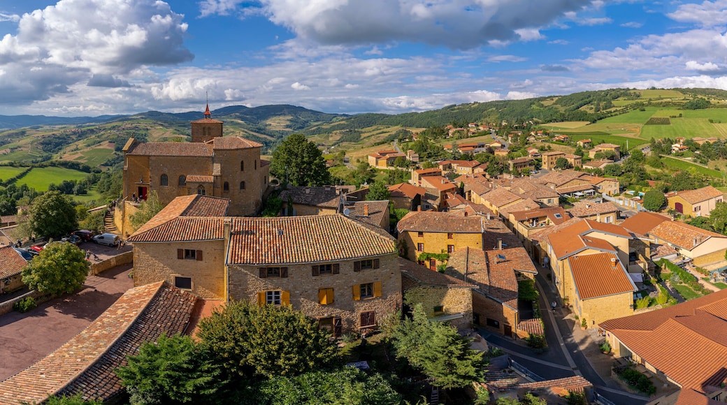 Val d'Oingt, France - 08 29 2021: Rhône Vineyard. View of the Saint-Mathieu de Oingt Church and the village with the vine field and countryside around.