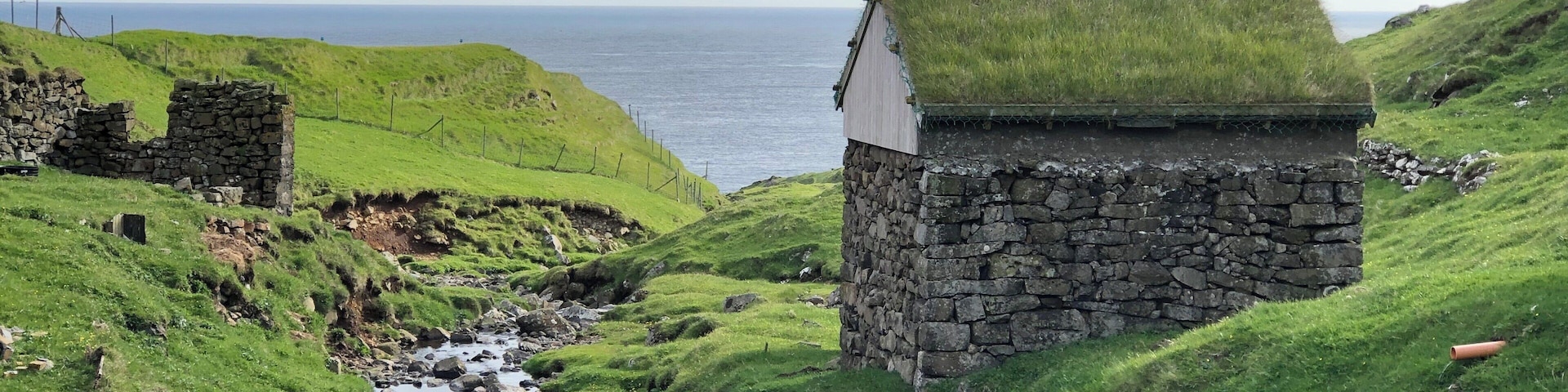 The small village on Mykines only has about a dozen year long residents. The helicopter supplies them twice a week and takes them to one of the other islands if they have the need. During the summer many visitors come to see the birds that nest on the island or one of the islets close by. There are also summer residents many who have family history on the island. This old stone building houses supplies and equipment.