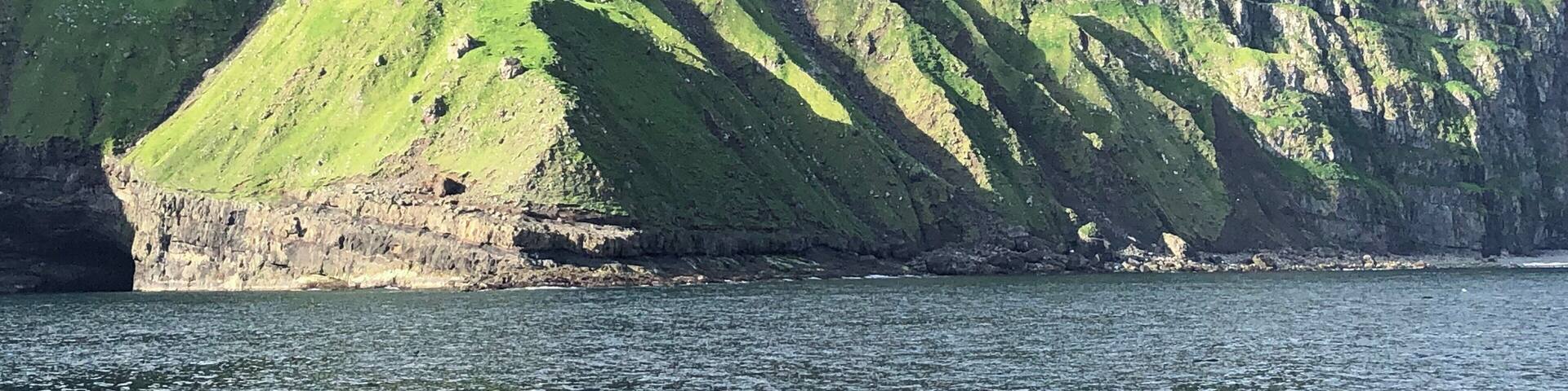 The cliffs of the island of Mykines in the Faroe Islands. Quite a view to and from the small harbor there.
