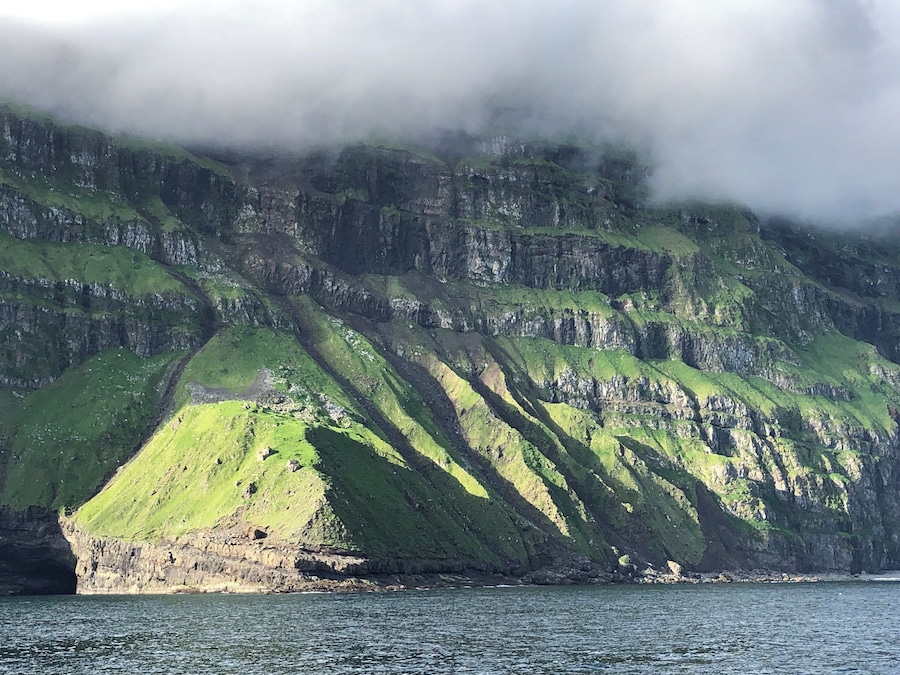 The cliffs of the island of Mykines in the Faroe Islands. Quite a view to and from the small harbor there.