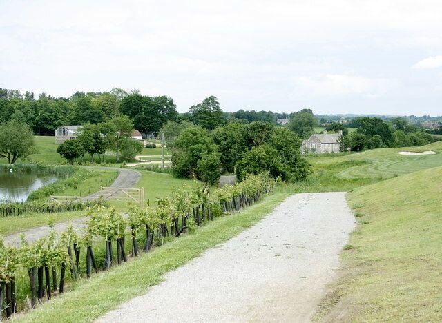 The Macmillan Way in Cumberwell Park The Macmillan Way follows a track which has been made up as a service road for the Cumberwell Park Golf Course. Cherry Orchard Farm is seen with Lower Wraxall just visible.