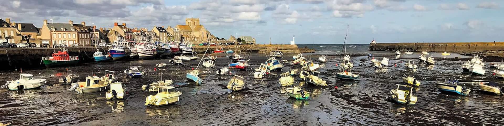 In Normandy, on the English Channel, Barfleur is a gentle sea town with dramatic tides.
1066: A large medallion fixed to a rock in the harbour marks the Normans' departure from Barfleur before the battle of Hastings