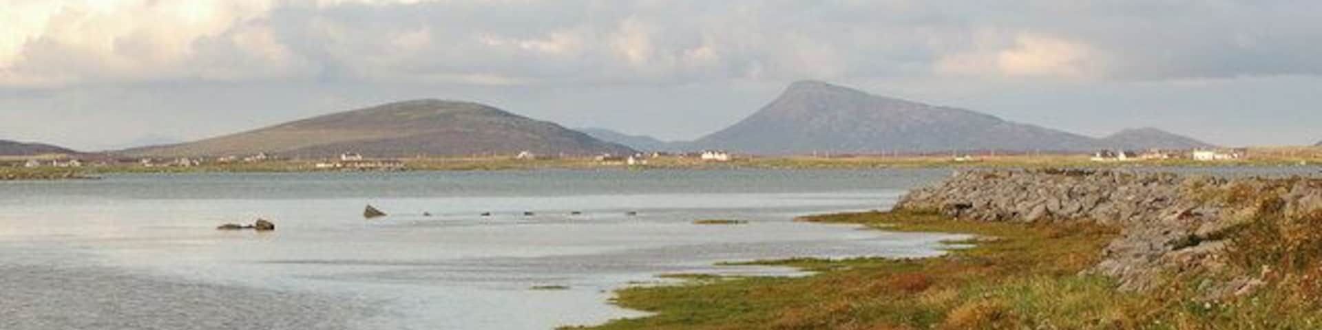 South Ford, Eochar. Looking NE towards Rueval on Benbecula and Eaval on North Uist, from the spot which suffered tragic loss of life in the 2004 hurricane.