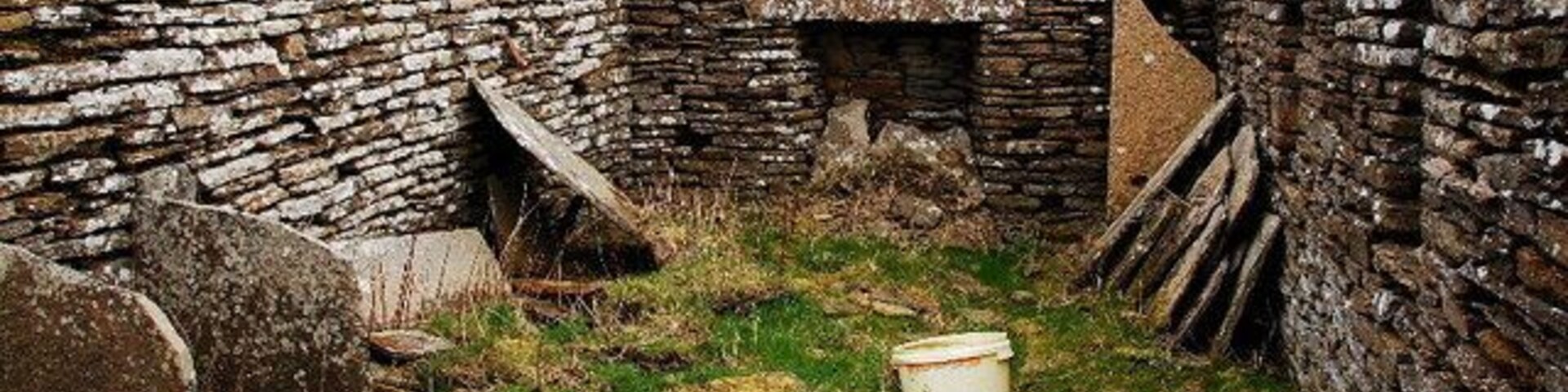 Derelict crofthouse The stark reality of bygone rural life in Orkney is all too evident here. No romantic, rose-tinted rural idyll. The most basic accommodation, peat fire, tiny windows down one side and a low roof. That's some lintel over the fireplace though.
