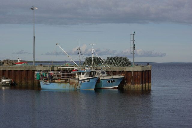 Tingwall Pier Two fishing vessels are tied up at the pier on a calm evening.