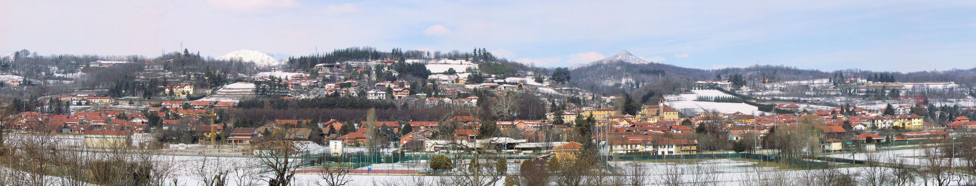 A snow-covered town with a prominent mountain in the background.