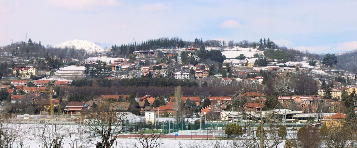 A snow-covered town with a prominent mountain in the background.