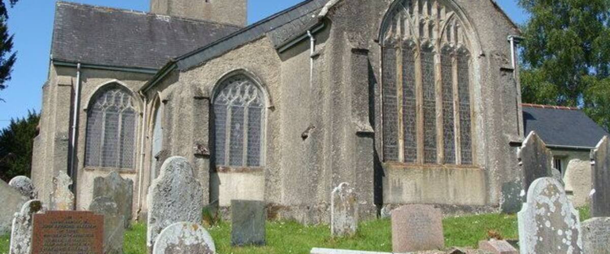 A historic church with a tall tower and arched windows.