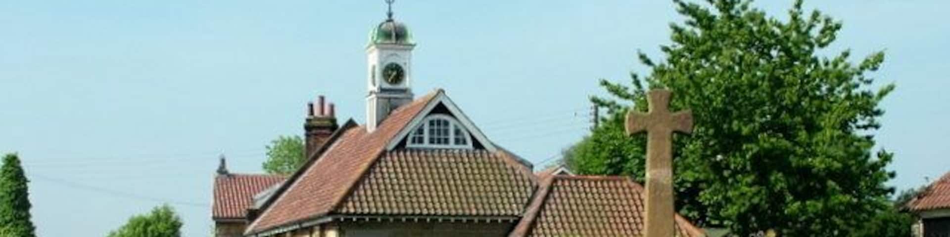 War Memorial at Ingleby Cross There is an interesting clock and weather vane on the building behind.