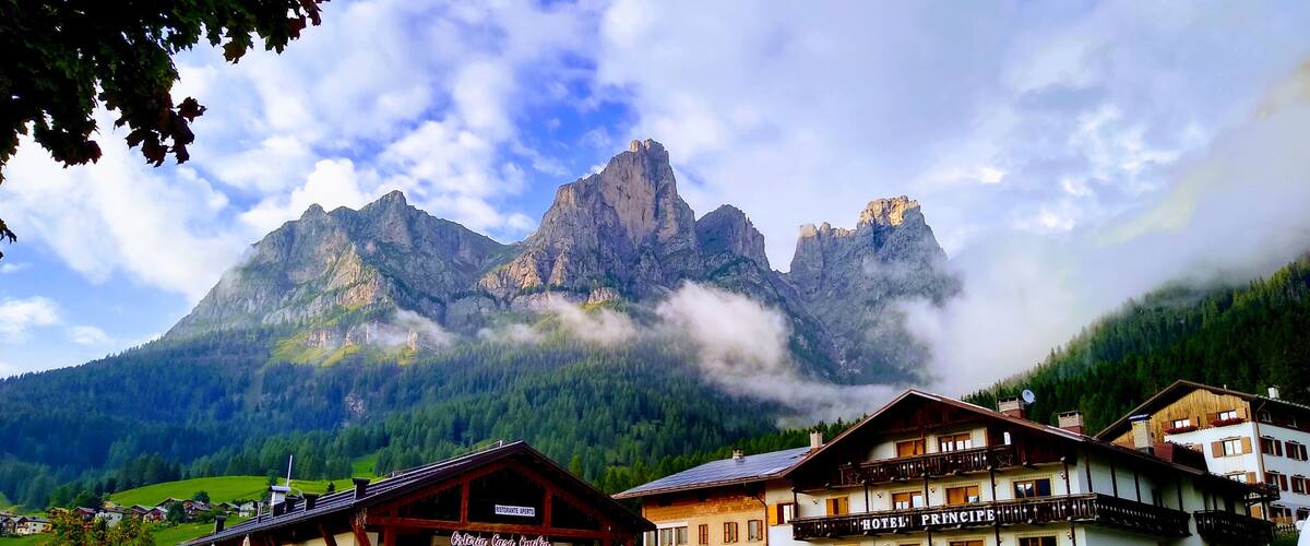 A mountain town with a prominent peak, a restaurant, and a hotel.