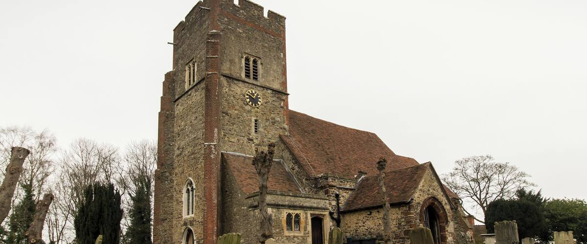 A historic church with a tall tower and a clock.