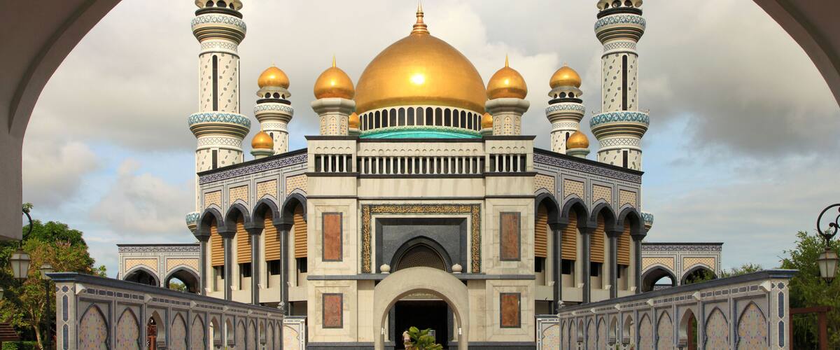A grand mosque with golden domes and intricate architecture.
