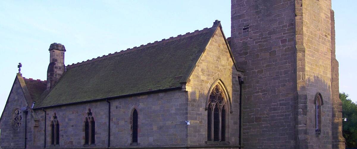 A historic church with a tall tower and a traditional stone facade.