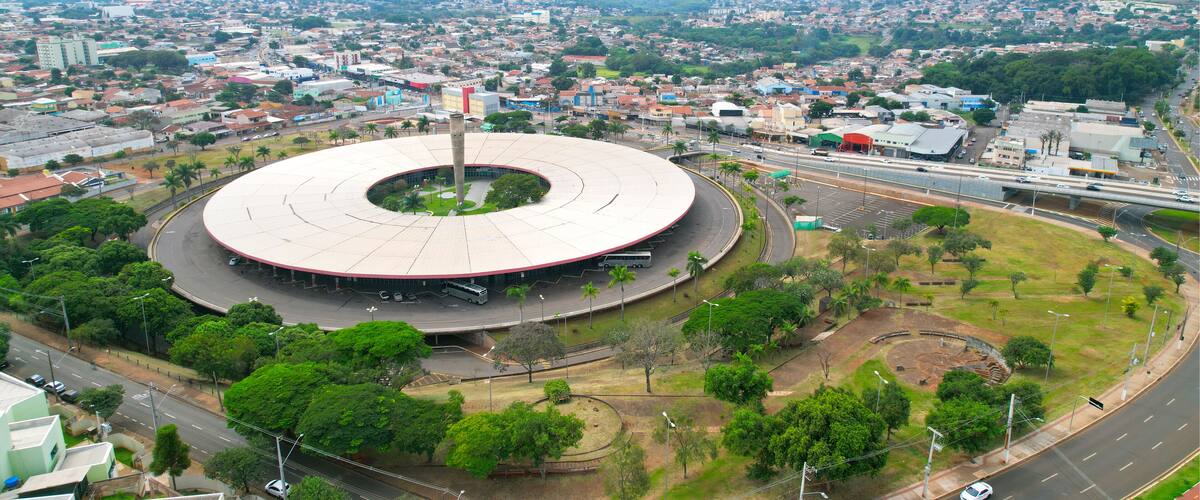 A large circular stadium surrounded by roads and greenery.