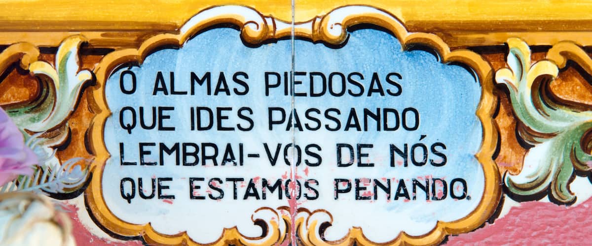 A decorative plaque with ornate golden borders and a blue background.