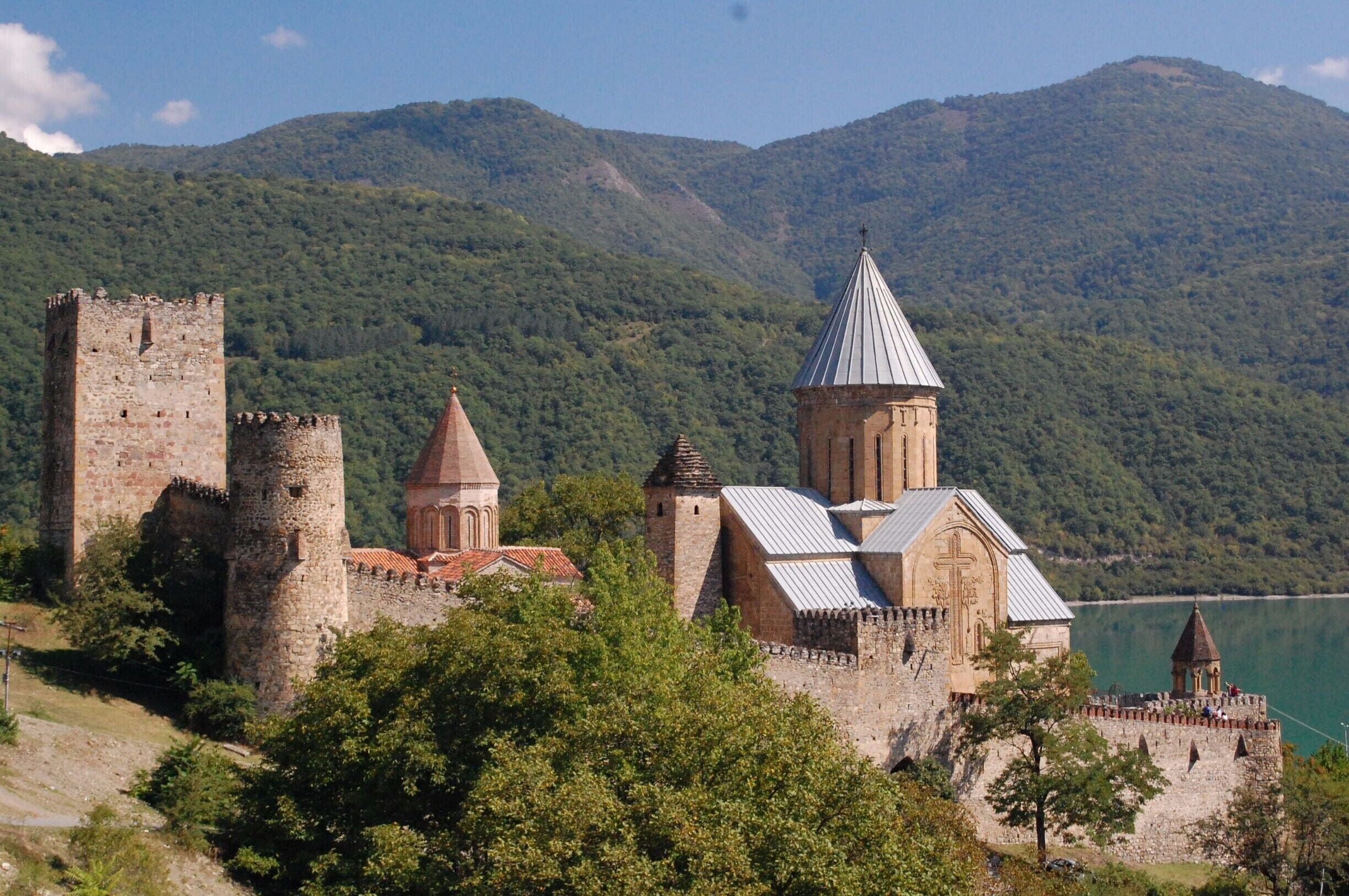 Ananuri Fortress, which dates from the 13th century, was once home to the Duchy of Aragvi. The complex is comprised of two castles, of which the upper one is well preserved, and two churches. The Church of the Assumption (Ghvtismshobeli), which dates from 1689, has decorative facades and some impressive frescoes that survived the fire of 1739. The site was strategic location and the scene of numerous battles throughout history, including the massacre of the Aragvi clan in 1739. The best views of the fortress are from the road bridge, with the mountains and Zhinvali reservoir as the backdrop.

For more information please see my blog post - http://www.greengoulash.com/kazbegi/

#architecture #instone #church #fortress #castle #history