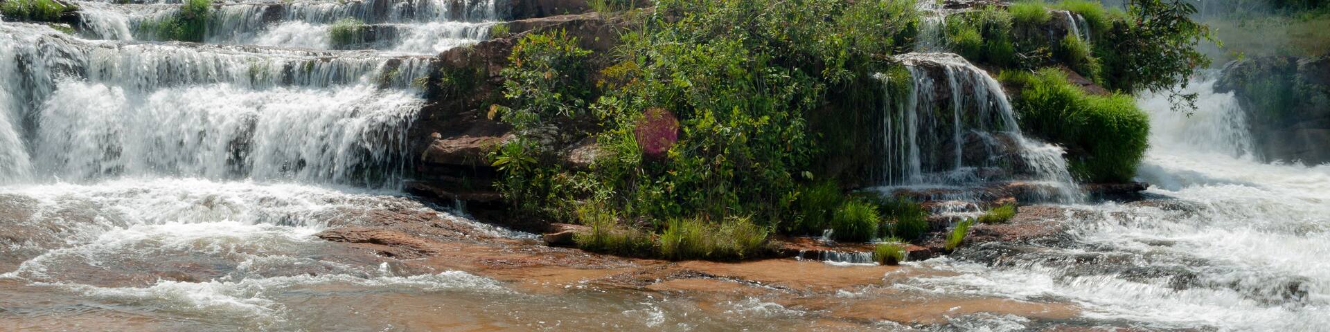 Tropical waterfall with blue sky and white clouds