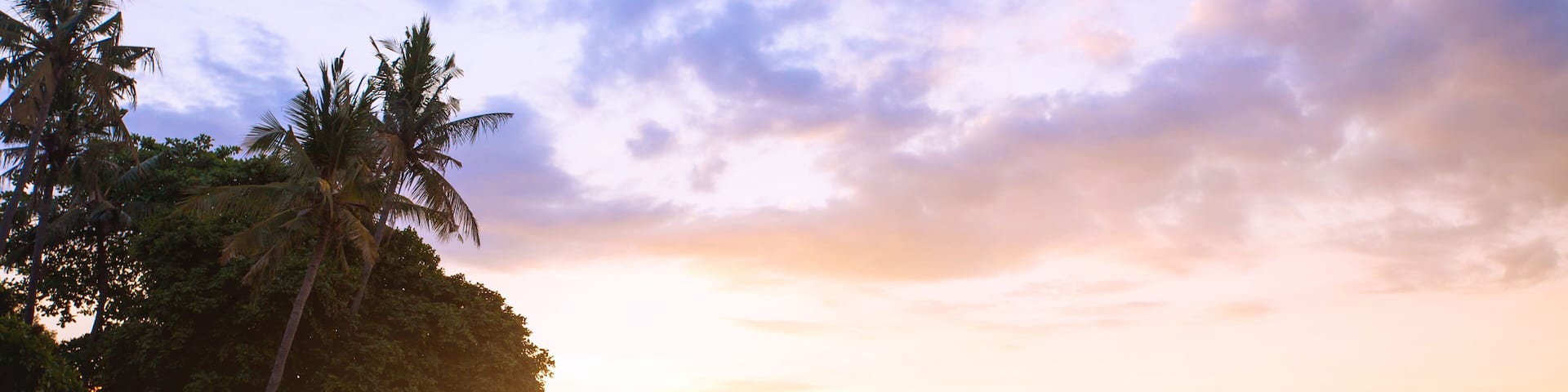 beautiful beach in Bali at sunset, exotic landscape with boats and palm trees