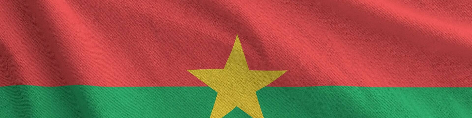 Burkina Faso flag depicted on folded wavy fabric of old cloth close up