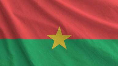 Burkina Faso flag depicted on folded wavy fabric of old cloth close up