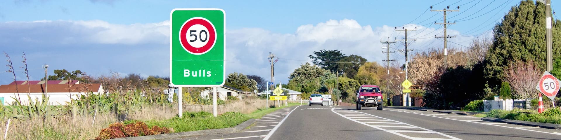 Road sign designating a fifty kilometer per hour speed zone travelling through the town of Bulls in the Rangitikei District. of New Zealand