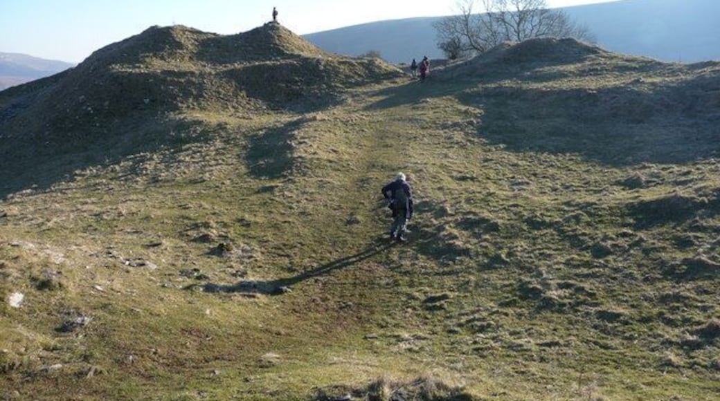 Inside Castell Dinas Human figures show the scale of this Iron Age hillfort and subsequent Norman castle site.