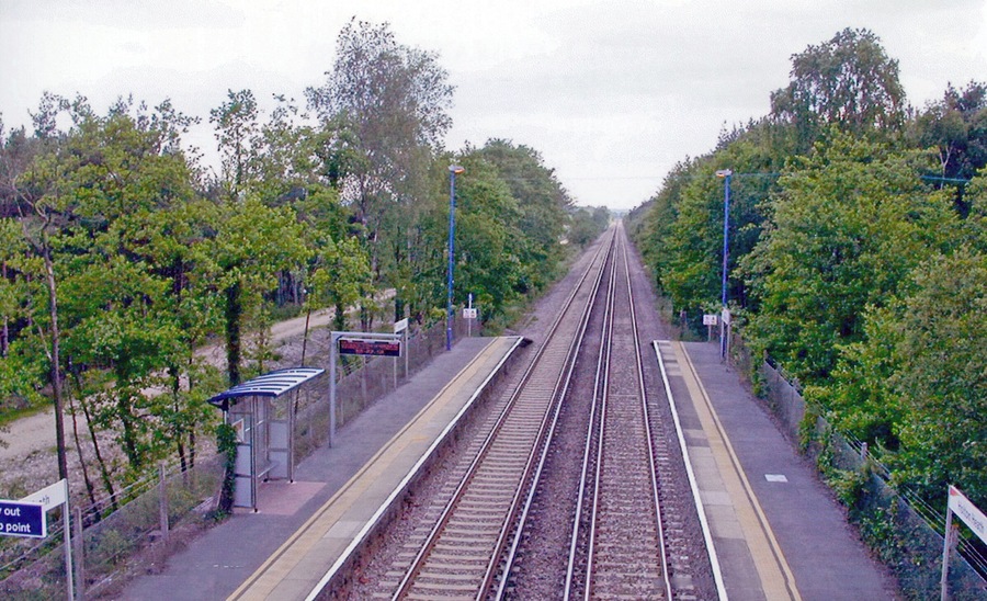 Holton Heath station. View SW, towards Dorchester and Weymouth: ex-LSWR London - Southampton etc. - Bournemouth - Wareham - Dorchester - Weymouth main line, electrified 1988.